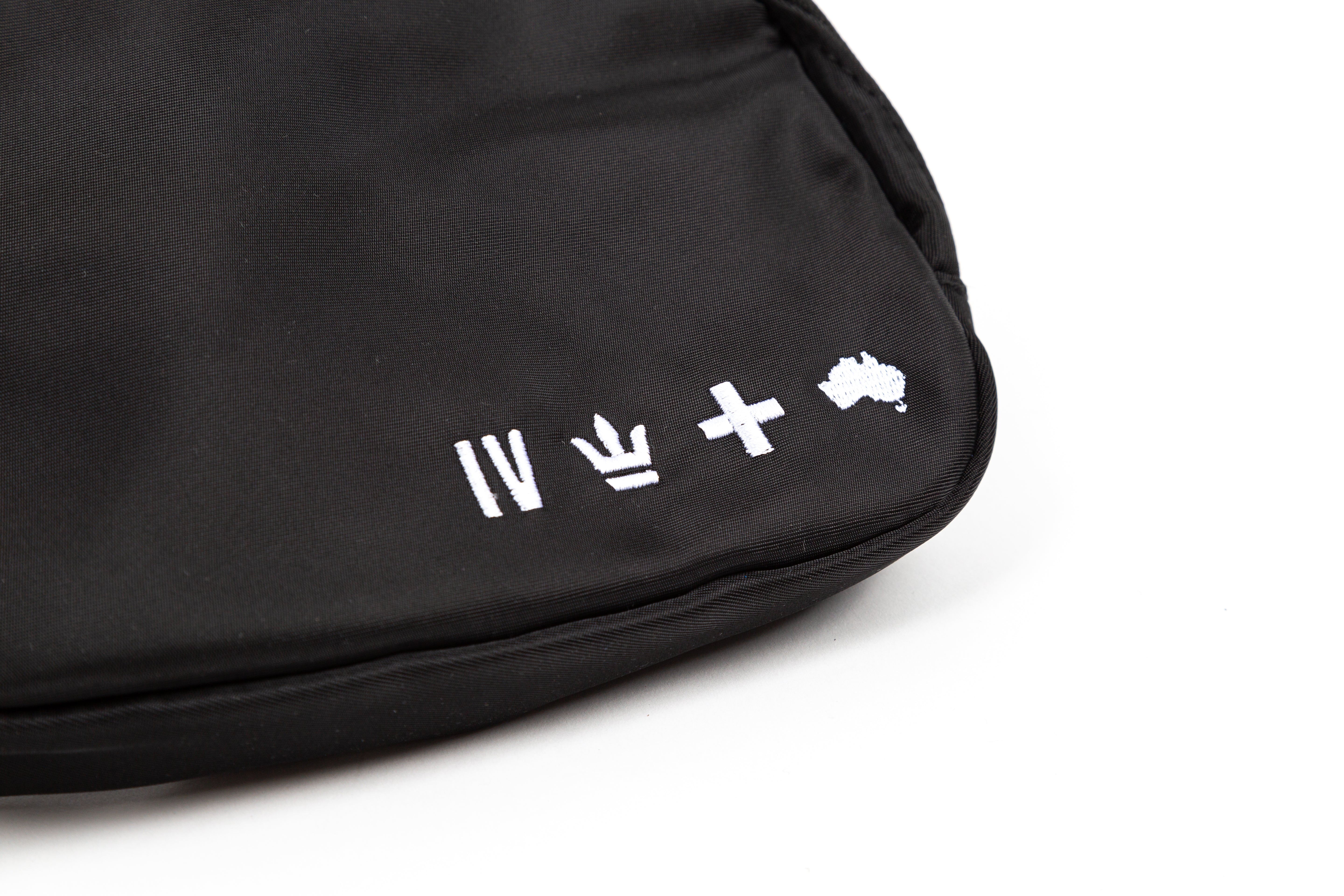 black for KING + COUNTRY fanny pack front view strap bag embroidered symbols nylon belt close up
