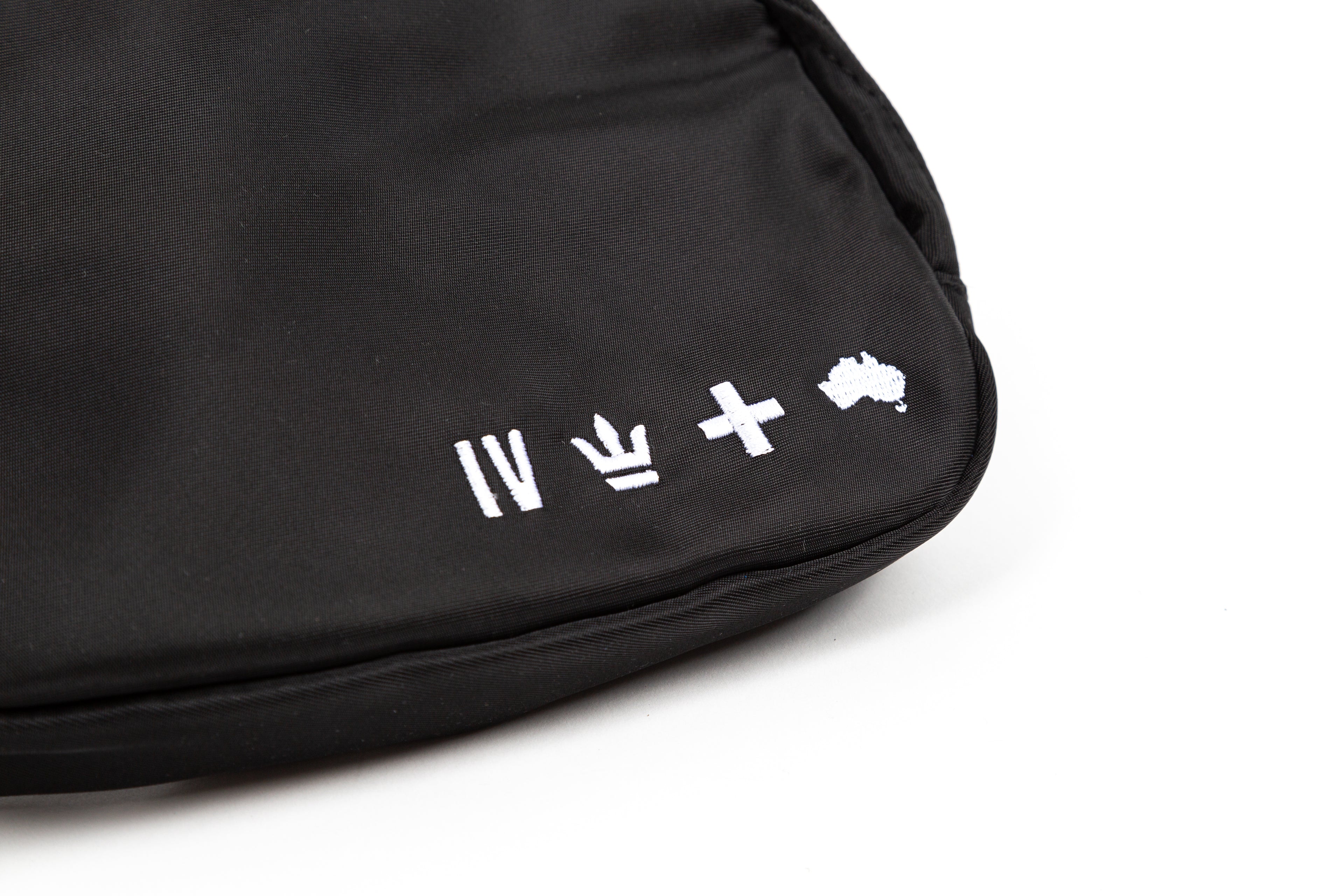 black for KING + COUNTRY fanny pack front view strap bag embroidered symbols nylon belt close up